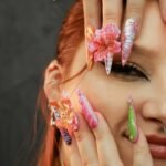 Vibrant and intricate nail art on a woman's hands, showcasing creativity and style.